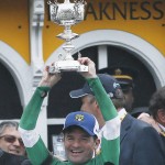 Rocky Kent Desormeaux holds a trophy after Exaggerator he rode won the 141st Preakness Stakes horse race at Pimlico Race Course, Saturday, May 21, 2016, in Baltimore.  (AP Photo/Matt Slocum)
