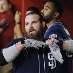 San Diego Padres' Derek Norris pulls off his batting gloves after hitting a two-run home run against the Arizona Diamondbacks during the fifth inning of a baseball game Friday, May 27, 2016, in Phoenix. (AP Photo/Ross D. Franklin)