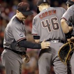Arizona Diamondbacks starting pitcher Patrick Corbin, right, gets a pat from manager Chip Hale as Corbin leaves a baseball game against the St. Louis Cardinals during the seventh inning Friday, May 20, 2016, in St. Louis. (AP Photo/Jeff Roberson)