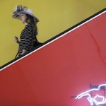 A woman moves down an escalator ahead of the 141st Preakness Stakes horse race at Pimlico Race Course, Saturday, May 21, 2016, in Baltimore.  (AP Photo/Matt Slocum)