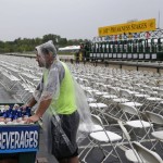 A beer vendor waits for customers as rain falls at Pimlico Race Course in Baltimore, Saturday, May 21, 2016, before the 141st running of the Preakness Stakes horse race. (AP Photo/Patrick Semansky)