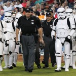 The umpire crew, lead by home plate umpire Jerry Layne, middle, is escorted to the plate by Star Wars character Stormtroopers on Star Wars Night at Chase Field prior to a baseball game between the Arizona Diamondbacks and the San Francisco Giants Saturday, May 14, 2016, in Phoenix. (AP Photo/Ross D. Franklin)