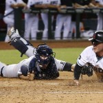 Arizona Diamondbacks' Chris Herrmann, right, scores a run ahead of the tag by New York Yankees' Brian McCann, left, during the third inning of a baseball game Tuesday, May 17, 2016, in Phoenix. (AP Photo/Ross D. Franklin)