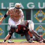 Pittsburgh Pirate second baseman Sean Rodriguez applies the late tag as Arizona Diamondbacks' Chris Owings is safe with a double during the second inning of a baseball game, Thursday, May 26, 2016 in Pittsburgh. (AP Photo/John Heller)