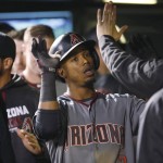 Arizona Diamondbacks' Jean Segura is congratulated after hitting a solo home run off Colorado Rockies starting pitcher Tyler Chatwood in the fifth inning of a baseball game Monday, May 9, 2016, in Denver. (AP Photo/David Zalubowski)
