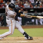 San Francisco Giants' Buster Posey connects for a two-run double against the Arizona Diamondbacks during the ninth inning of a baseball game Saturday, May 14, 2016, in Phoenix. (AP Photo/Ross D. Franklin)