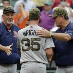 Boston Red Sox starting pitcher Steven Wright (35) is greeted by pitching coach Carl Willis, left, and manager John Farrell after closing out a baseball game against the Baltimore Orioles in Baltimore, Monday, May 30, 2016. Boston won 7-2. (AP Photo/Patrick Semansky)