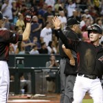 Arizona Diamondbacks' Chris Herrmann, right, celebrates his run scored against the San Francisco Giants with Nick Ahmed (13) during the second inning of a baseball game Saturday, May 14, 2016, in Phoenix. (AP Photo/Ross D. Franklin)