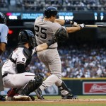 New York Yankees' Mark Teixeira (25) connects for a single as Arizona Diamondbacks catcher Chris Herrmann and umpire CB Bucknor, left, watch during the first inning of a baseball game, Monday, May 16, 2016, in Phoenix. (AP Photo/Ross D. Franklin)