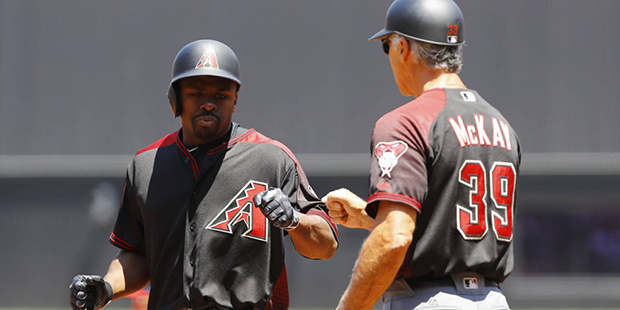 Arizona Diamondbacks' Michael Bourn, left, is congratulated by first base coach Dave McKay after hi...