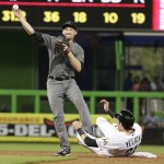 Miami Marlins' Christian Yelich (21) is out at second as Arizona Diamondbacks second baseman Phil Gosselin throws to first during the first inning of a baseball game, Tuesday, May 3, 2016, in Miami. (AP Photo/Lynne Sladky)