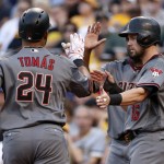 Arizona Diamondbacks' Yasmany Tomas (24) is greeted by Chris Owings (16) who was on base for his two run home run off Pittsburgh Pirates starting pitcher Jeff Locke in the second inning of a baseball game in Pittsburgh, Wednesday, May 25, 2016. (AP Photo/Gene J. Puskar)