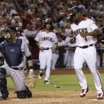 Arizona Diamondbacks' Michael Bourn, right, scores a run on a bases-loaded walk by New York Yankees pitcher Conor Mullee as Yankees catcher Austin Romine, left, kneels at home plate during the sixth inning of a baseball game Monday, May 16, 2016, in Phoenix. (AP Photo/Ross D. Franklin)