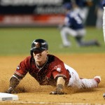 Arizona Diamondbacks Chris Herrmann dives into third base after hitting a triple against the San Diego Padres in the seventh inning during a baseball game, Sunday, May 29, 2016, in Phoenix. (AP Photo/Rick Scuteri)