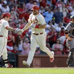 St. Louis Cardinals' Matt Adams, center, is congratulated by teammate Jedd Gyorko, left, after hitting a solo home run as Arizona Diamondbacks catcher Welington Castillo, right, stands by during the sixth inning of a baseball game Saturday, May 21, 2016, in St. Louis. (AP Photo/Jeff Roberson)