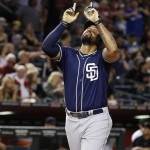 San Diego Padres' Matt Kemp points to the sky as he arrives at home plate after hitting a home run against the Arizona Diamondbacks during the fifth inning of a baseball game Friday, May 27, 2016, in Phoenix. (AP Photo/Ross D. Franklin)