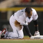 Arizona Diamondbacks' Jean Segura kneels at first base after being picked off on a throw by New York Yankees pitcher Michael Pineda during the first inning of a baseball game Tuesday, May 17, 2016, in Phoenix. (AP Photo/Ross D. Franklin)