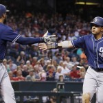 San Diego Padres' Jon Jay, right, slaps hands with Matt Kemp after Jay scored against the Arizona Diamondbacks during the third inning of a baseball game Friday, May 27, 2016, in Phoenix. (AP Photo/Ross D. Franklin)