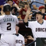 Arizona Diamondbacks' Jean Segura (2) celebrates his run scored against the New York Yankees with manager Chip Hale (3) during the third inning of a baseball game Tuesday, May 17, 2016, in Phoenix. (AP Photo/Ross D. Franklin)