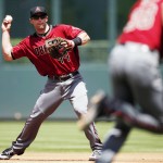 Arizona Diamondbacks first baseman Paul Goldschmidt looks to throw the ball to starting pitcher Robbie Ray as he goes to cover first base after Goldschmidt fielded a ground ball hit by Colorado Rockies' Nolan Arenado in the first inning of a baseball game Wednesday, May 11, 2016, in Denver. Ray was late to the bag and Arenado was given an infield hit on the play. (AP Photo/David Zalubowski)