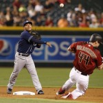 San Diego Padres second baseman Alexi Amarista, left, gets the force out on Arizona Diamondbacks Paul Goldschmidt in the first inning during a baseball game, Sunday, May 29, 2016, in Phoenix. (AP Photo/Rick Scuteri)