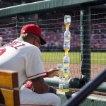 St. Louis Cardinals' Carlos Martinez stacks water bottles in the dugout during the sixth inning of a baseball game against the Arizona Diamondbacks, Saturday, May 21, 2016, in St. Louis. (AP Photo/Jeff Roberson)