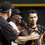 San Francisco Giants' Buster Posey, right, is congratulated by manager Bruce Bochy, left, and third base coach Roberto Kelly, middle, after a baseball game against the Arizona Diamondbacks on Saturday, May 14, 2016, in Phoenix. The Giants defeated the Diamondbacks 5-3. (AP Photo/Ross D. Franklin)