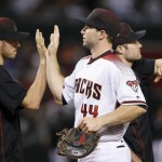 Arizona Diamondbacks' Paul Goldschmidt (44) celebrates a win against the New York Yankees with pitcher Patrick Corbin, left, and injured A.J. Pollock, right, after a baseball game Monday, May 16, 2016, in Phoenix. The Diamondbacks defeated the Yankees 12-2. (AP Photo/Ross D. Franklin)