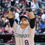 Colorado Rockies' Gerardo Parra points to the sky as he arrives at home plate after hitting a home run against the Arizona Diamondbacks during the fifth inning of a baseball game, Sunday, May 1, 2016, in Phoenix. (AP Photo/Ross D. Franklin)