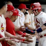 St. Louis Cardinals' Yadier Molina, right, is congratulated by teammates in the dugout after hitting a two-run home run during the seventh inning of a baseball game against the Arizona Diamondbacks, Saturday, May 21, 2016, in St. Louis. (AP Photo/Jeff Roberson)