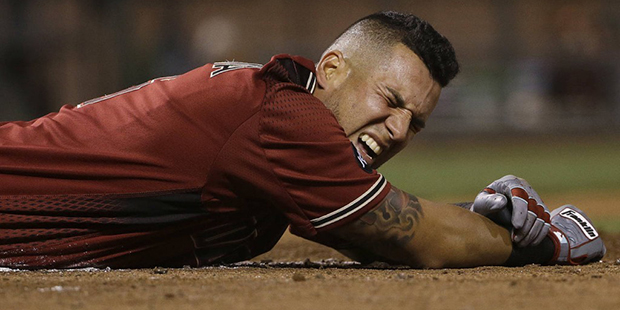 Arizona Diamondbacks' David Peralta reacts after being hit by a pitch during the ninth inning of th...