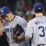 San Diego Padres pitcher Cesar Vargas, left, wipes sweat from his face as he gets a visit from Brett Wallace after giving up three runs to the Arizona Diamondbacks during the second inning of a baseball game Saturday, May 28, 2016, in Phoenix. Vargas was removed later in the inning. (AP Photo/Ross D. Franklin)
