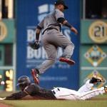 Pittsburgh Pirates' Starling Marte, bottom, steals second as Arizona Diamondbacks second baseman Jean Segura (2) leaps over him during the first inning of a baseball game in Pittsburgh, Tuesday, May 24, 2016. Marte advanced to third on the errant throw by catcher Welington Castillo. (AP Photo/Gene J. Puskar)