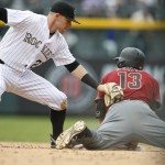 Colorado Rockies shortstop Trevor Story, left, applies a late tag as Arizona Diamondbacks' Nick Ahmed slides safely into second base with a leadoff double in the sixth inning of a baseball game Wednesday, May 11, 2016, in Denver. (AP Photo/David Zalubowski)