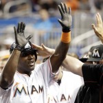 Miami Marlins center fielder Marcell Ozuna, left, is congratulated in the dugout after scoring on a double hit by Chris Johnson during the fourth inning of a baseball game against the Arizona Diamondbacks, Thursday, May 5, 2016, in Miami. (AP Photo/Lynne Sladky)