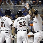 Miami Marlins' Giancarlo Stanton, right, is met at the plate by Christian Yelich (21) and Derek Dietrich (32) after hitting a two-run home run during the third inning of a baseball game against the Arizona Diamondbacks, Wednesday, May 4, 2016, in Miami. (AP Photo/Lynne Sladky)