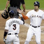 Miami Marlins' Giancarlo Stanton, right, is met by Adeiny Hechavarria, left,  after scoring on a single hit by Chris Johnson during the second inning of a baseball game against the Arizona Diamondbacks, Thursday, May 5, 2016, in Miami. (AP Photo/Lynne Sladky)