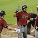 Arizona Diamondbacks' David Peralta, center, is met by Brandon Drury (27) and Jake Lamb, right, after hitting a two-run home run during the fifth inning of a baseball game against the Miami Marlins, Wednesday, May 4, 2016, in Miami. (AP Photo/Lynne Sladky)