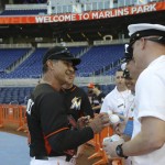 Miami Marlins manager Don Mattingly, left, signs autographs for sailors from the USS Bataan before a baseball game against the Arizona Diamondbacks, Thursday, May 5, 2016, in Miami. (AP Photo/Lynne Sladky)