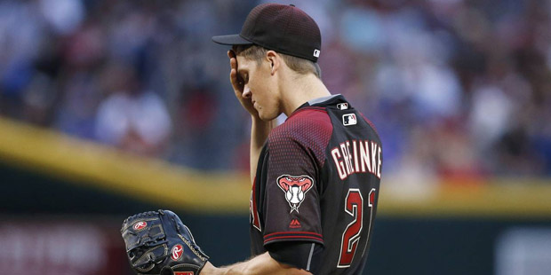 Arizona Diamondbacks' Zack Greinke wipes his forehead after giving up a run to the Chicago Cubs dur...