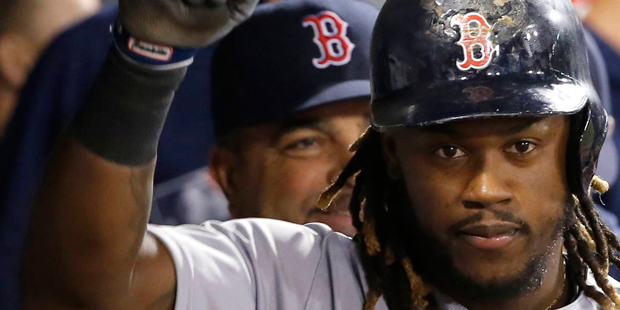 Boston Red Sox's Hanley Ramirez celebrates his home run in the dugout during the fifth inning of a ...