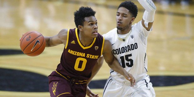 Arizona State guard Tra Holder, left, drives the lane for a basket as Colorado guard Dominique Coll...