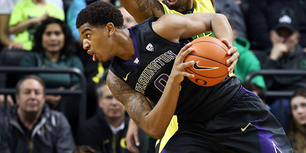 Washington's Marquese Chriss, foreground, battles Oregon's Elgin Cook for position under the basket...