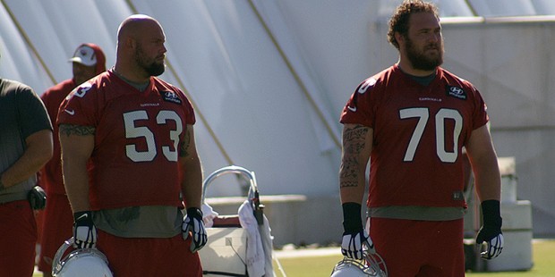 A.Q. Shipley (53) and Evan Boehm (70) watch during an OTA practice. (Photo by Adam Green/Arizona Sp...