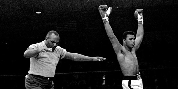 In this May 25, 1965, file photo, heavyweight champion Muhammad Ali raises his arms in victory as r...