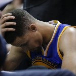 Golden State Warriors guard Stephen Curry (30) holds his head on the bench during a timeout against the Cleveland Cavaliers in the second half of Game 6 of basketball's NBA Finals in Cleveland, Thursday, June 16, 2016. (AP Photo/Tony Dejak)