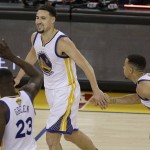 Golden State Warriors guard Klay Thompson, center, celebrates with forward Draymond Green (23) and guard Stephen Curry during the second half of Game 1 of basketball's NBA Finals against the Cleveland Cavaliers in Oakland, Calif., Thursday, June 2, 2016. The Warriors won 104-89. (AP Photo/Ben Margot)