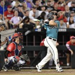 Coastal Carolina's Connor Owings hits a one-run single against Arizona in the eighth inning in Game 2 of the NCAA Men's College World Series finals baseball game in Omaha, Neb., Tuesday, June 28, 2016. (AP Photo/Ted Kirk)