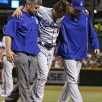Los Angeles Dodgers pitcher Kenta Maeda, of Japan, is helped off the field by athletic trainer Nate Lucero, left, and hitting coach Turner Ward during the sixth inning of a baseball game against the Arizona Diamondbacks Tuesday, June 14, 2016, in Phoenix. The Dodgers' Maeda was struck by a ball hit by Diamondbacks' Paul Goldschmidt. (AP Photo/Ross D. Franklin)