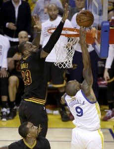 In this Sunday, June 19, 2016 photo, Cleveland Cavaliers forward LeBron James (23) blocks a shot by Golden State Warriors forward Andre Iguodala (9) during the second half of Game 7 of basketball's NBA Finals in Oakland, Calif. James had three blocked shots, including this key one against Iguodala on a fast break in the final minutes. The Cavaliers won 93-89. (AP Photo/Eric Risberg)